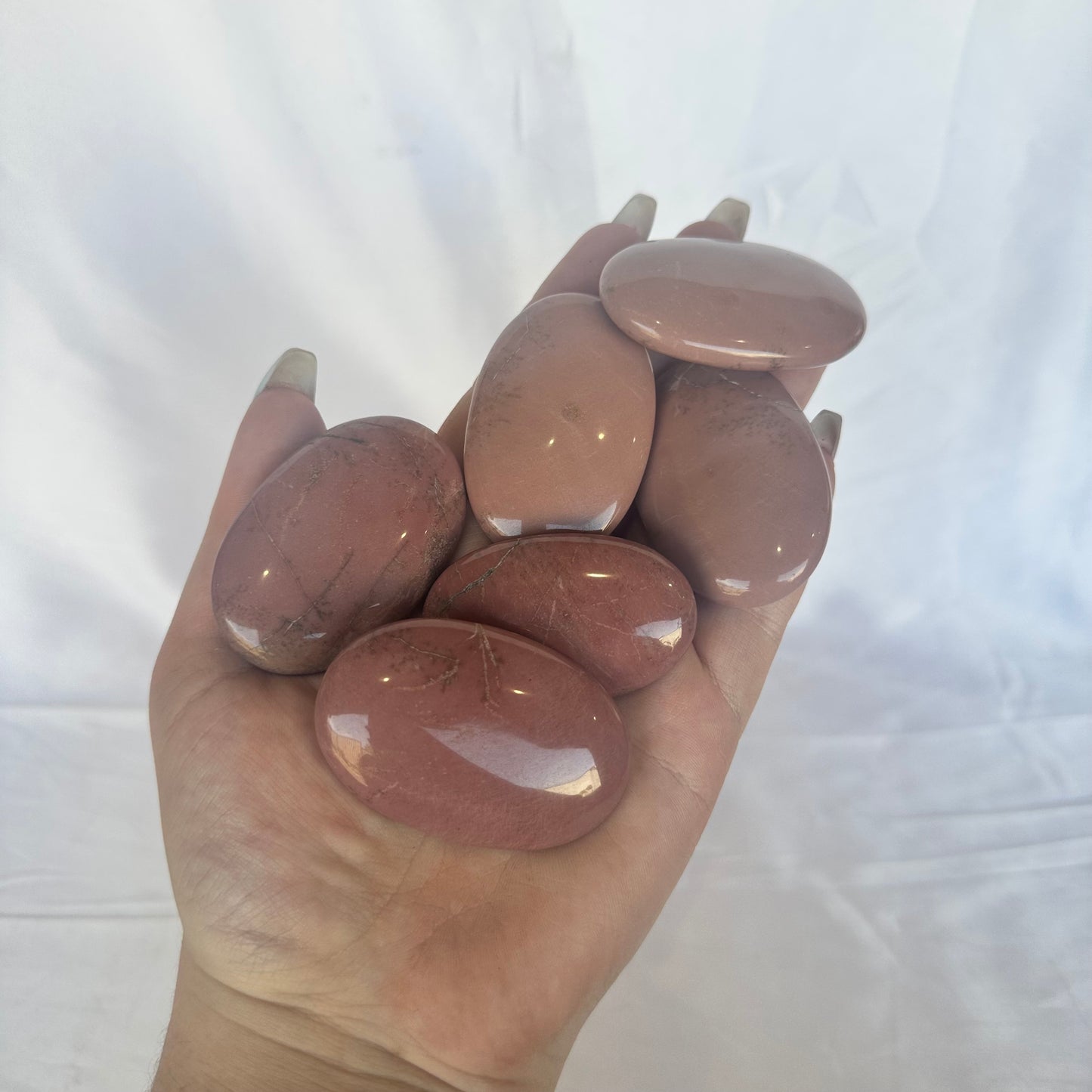 Pink petrified wood palm stones