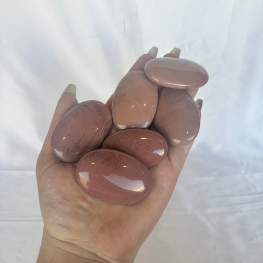 Pink petrified wood palm stones