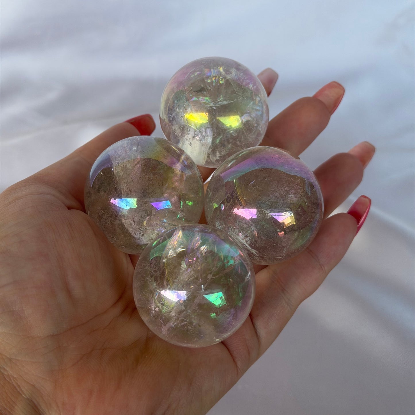 Aura coated rose quartz sphere
