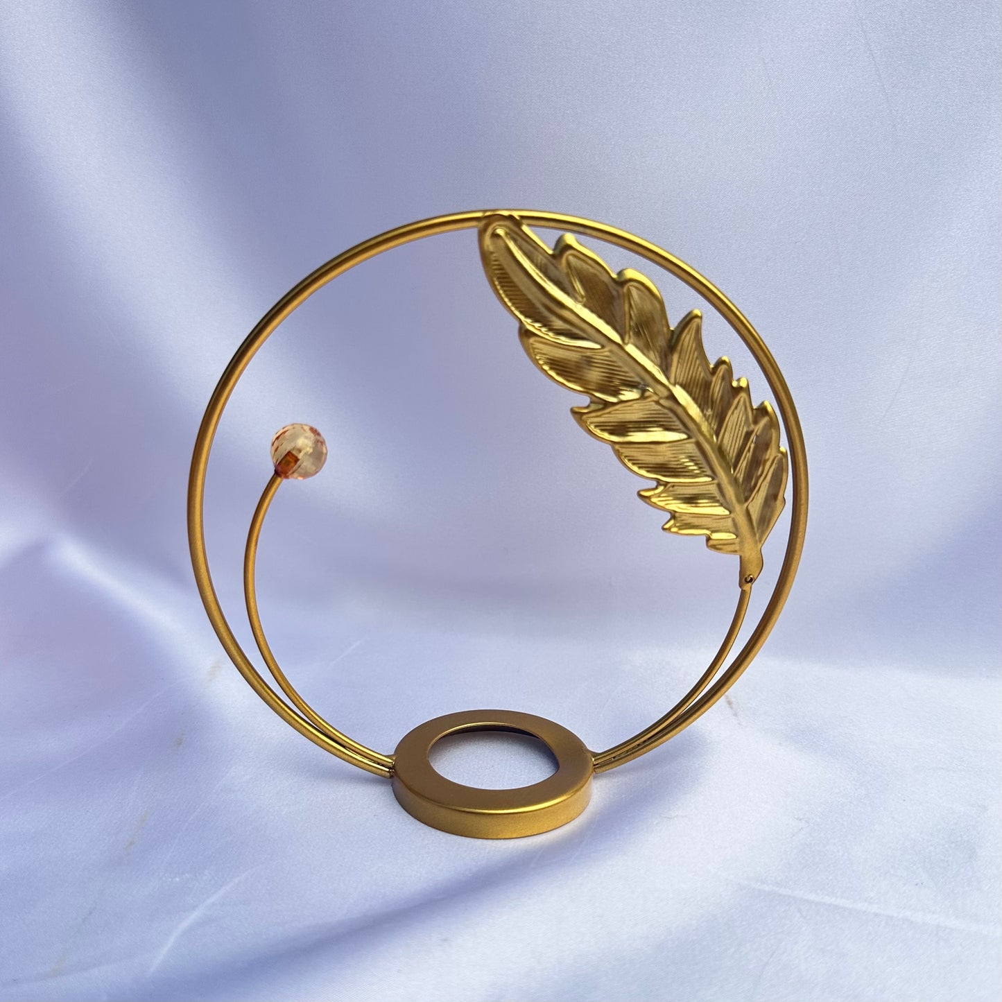 Gold leaf in flight sphere display stand
