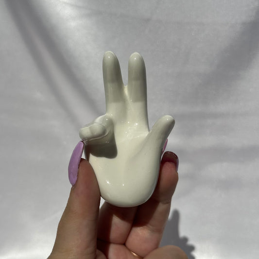 White ceramic hand sphere stand