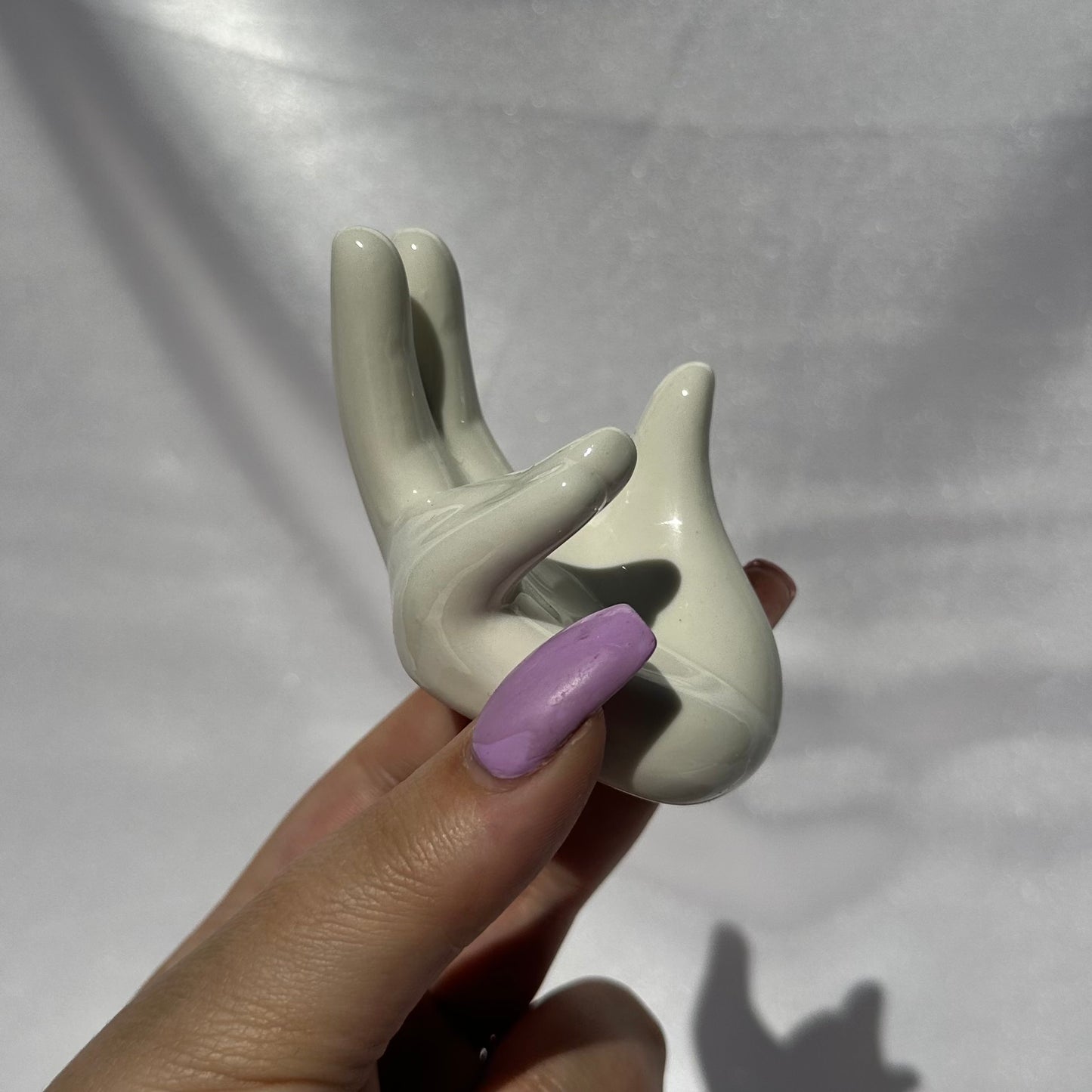 White ceramic hand sphere stand