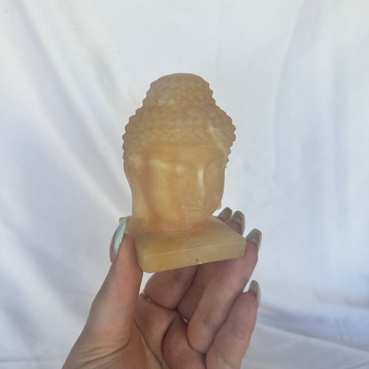 Orange calcite Buddha head